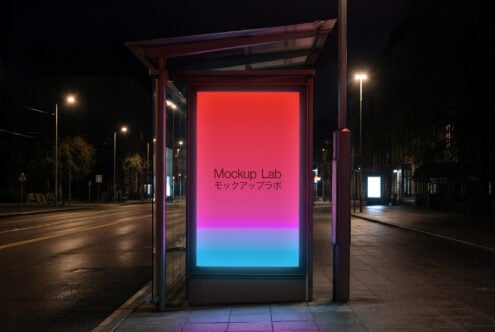 Lit bus shelter at night with gradient screen fading from magenta to blue on empty road