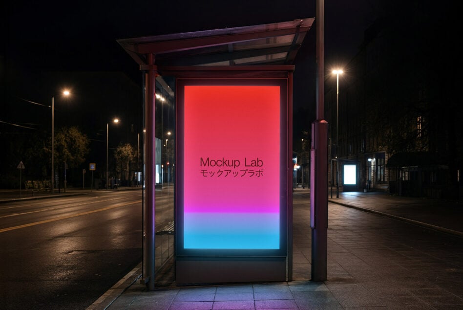 Lit bus shelter at night with gradient screen fading from magenta to blue on empty road