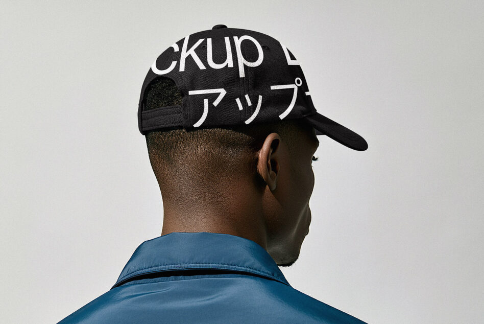 Back view of person wearing black baseball cap with white Japanese katakana text