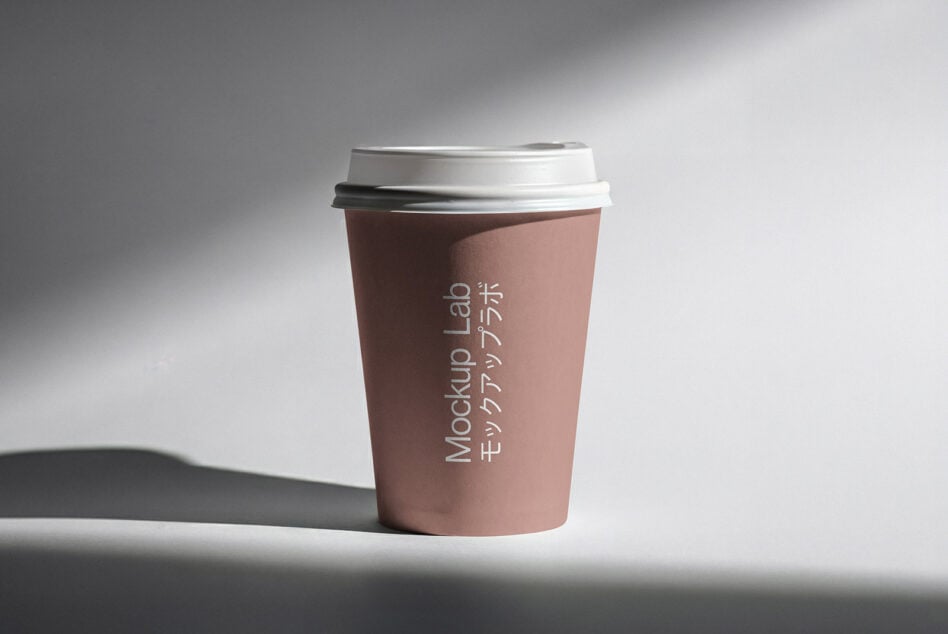 Rose-toned paper cup with white lid showing vertical text placement mockup