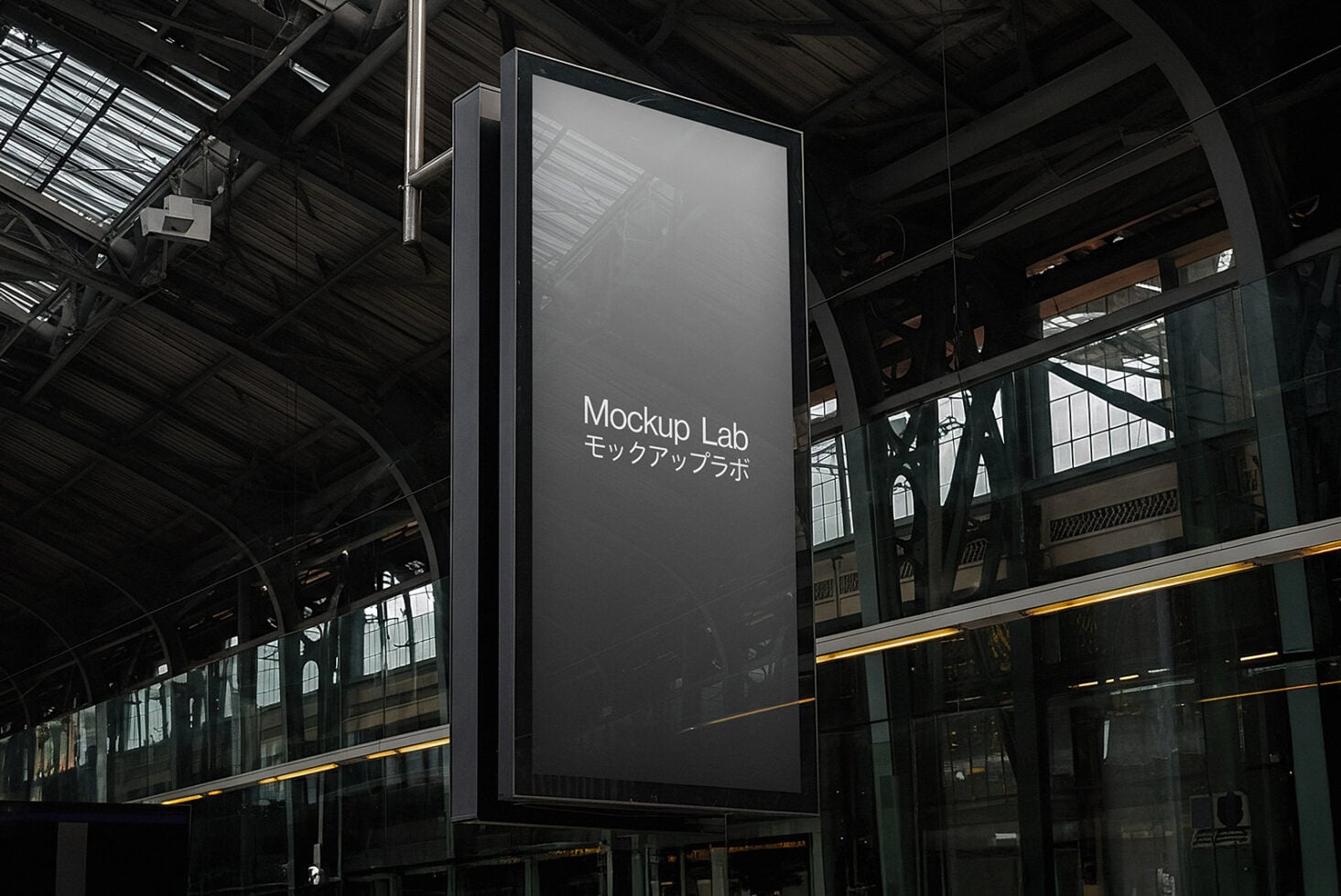 Empty metal sign display hanging from structure with dark industrial setting