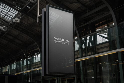 Empty metal sign display hanging from structure with dark industrial setting