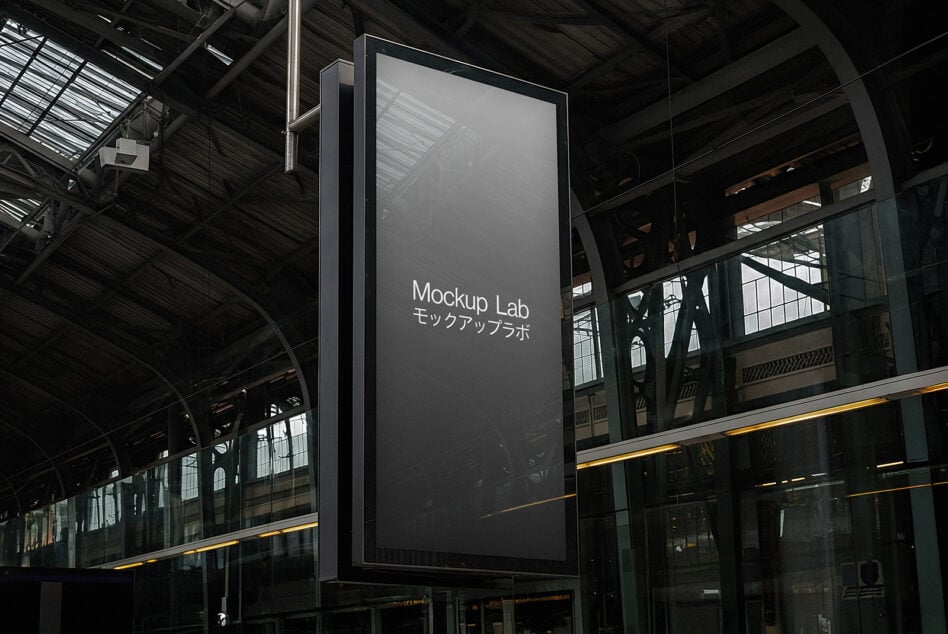 Empty metal sign display hanging from structure with dark industrial setting