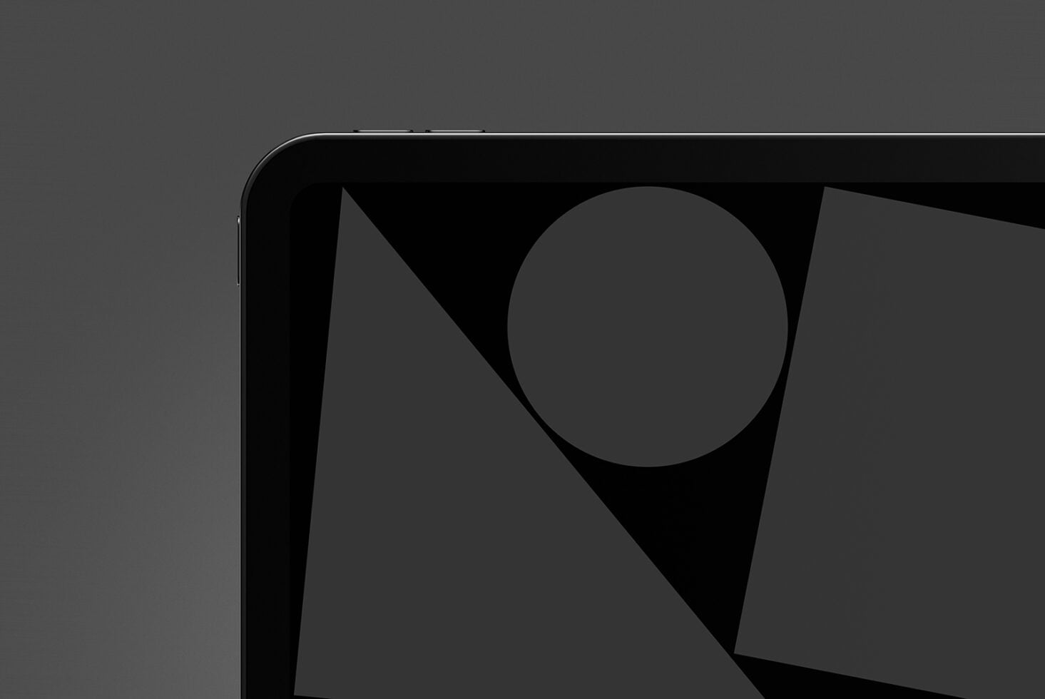Dark tablet screen with geometric shapes circle triangle on black surface