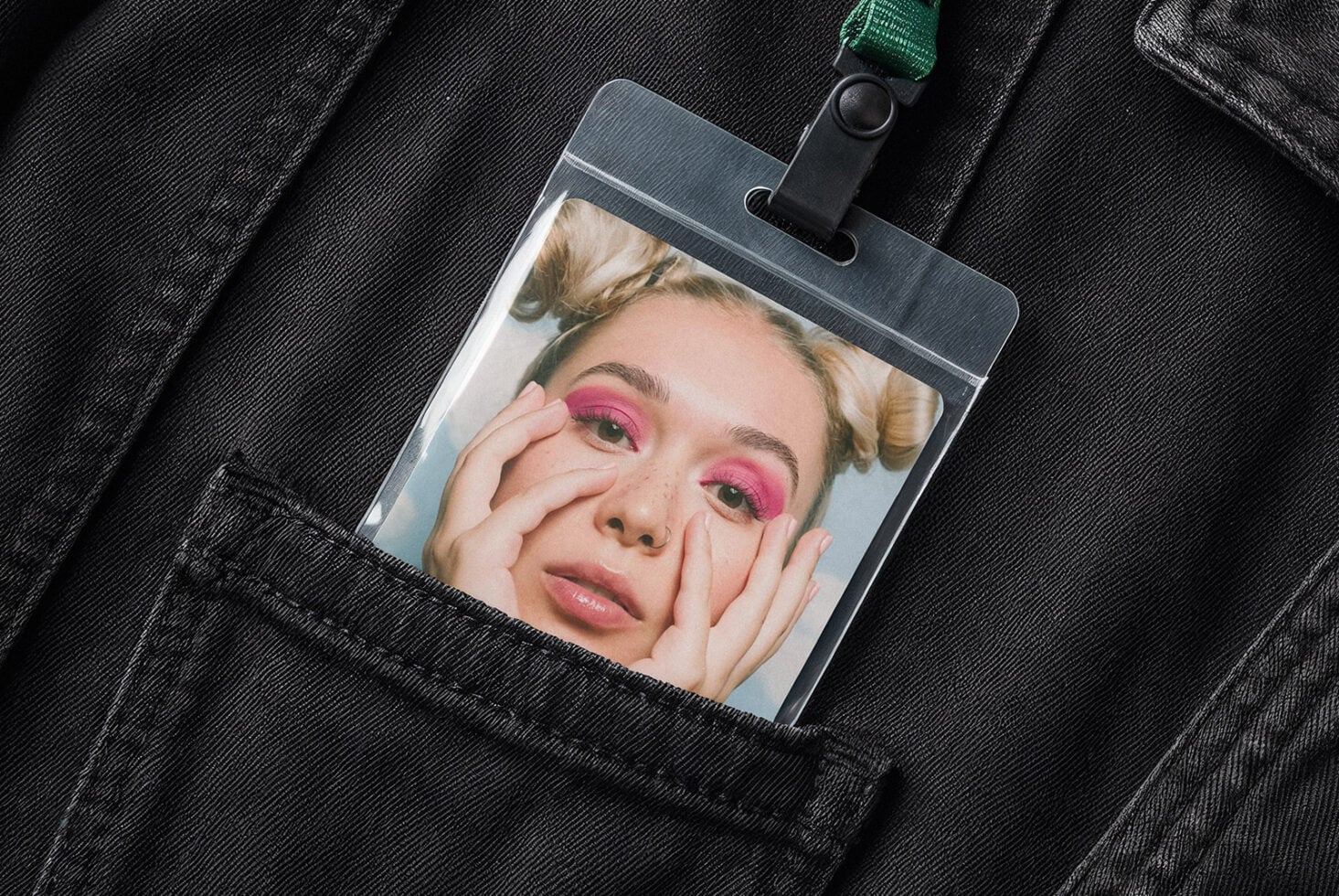 ID card mockup showing portrait photo on denim with green lanyard attached