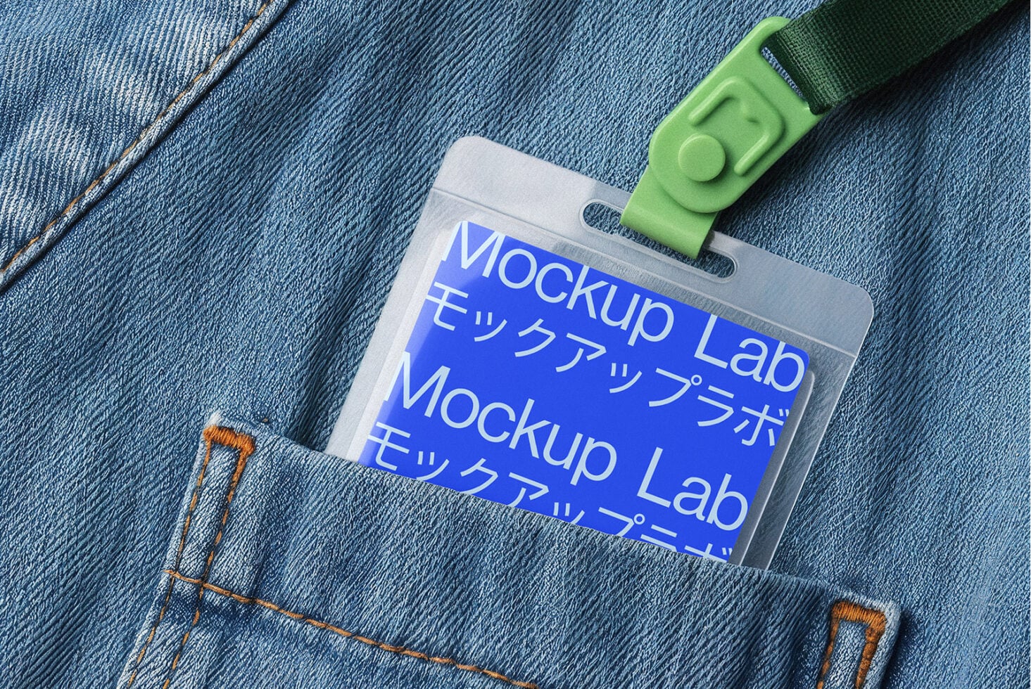 Blue ID card holder with green lanyard on blue denim fabric background