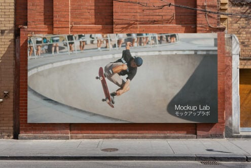 Large horizontal billboard with skateboarder mid-trick in concrete bowl