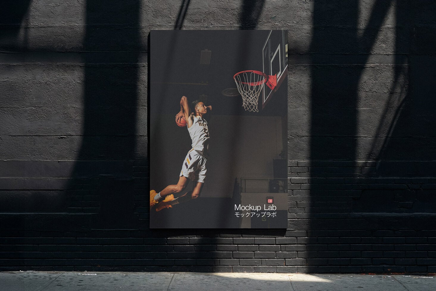 Vertical dark poster on brick showing basketball player mid shot with hoop