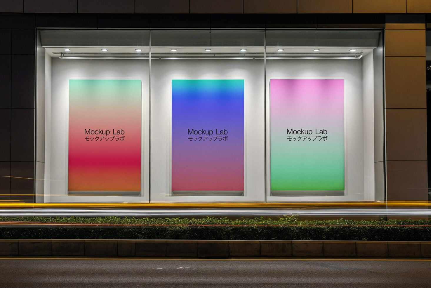 Lit storefront display with three gradient posters in mint, blue, pink colors
