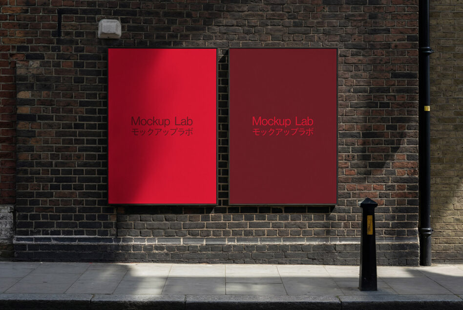 Two crimson red posters side by side on weathered dark brick building facade