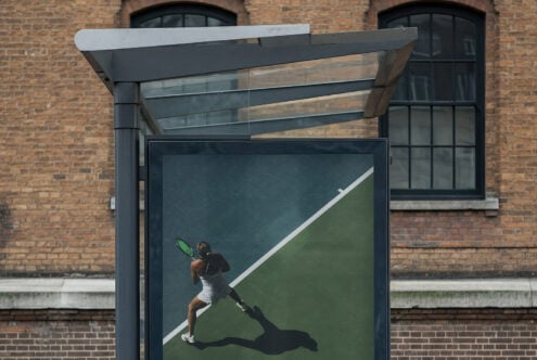 Modern bus shelter ad with tennis player serving on green court design
