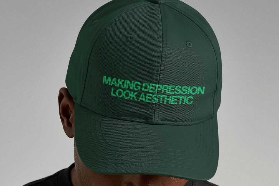 Back view of person wearing dark green baseball cap with bright green embroidered text