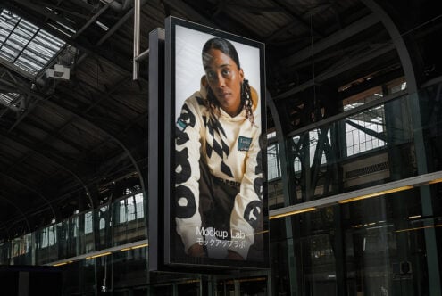 Portrait photo of person on vertical metal sign in warehouse space