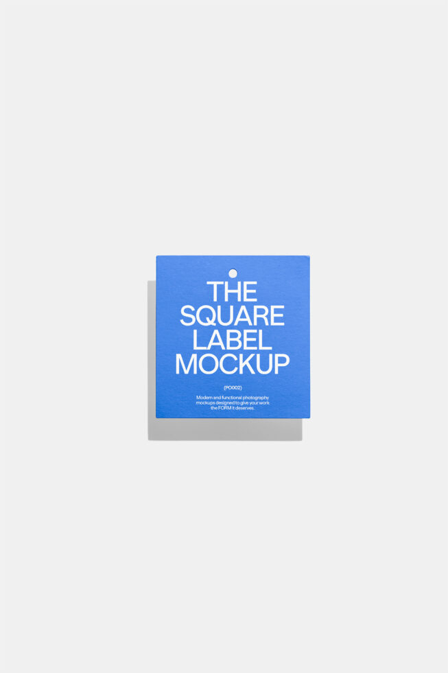 Square blue product label with hole punch on neutral background with shadow