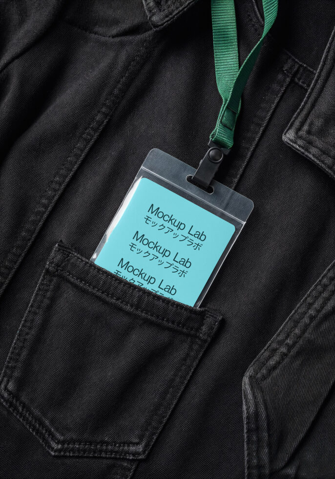 ID badge mockup with turquoise screen on black denim jacket with green lanyard