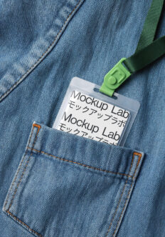 ID badge with green lanyard clipped to light blue denim jacket pocket