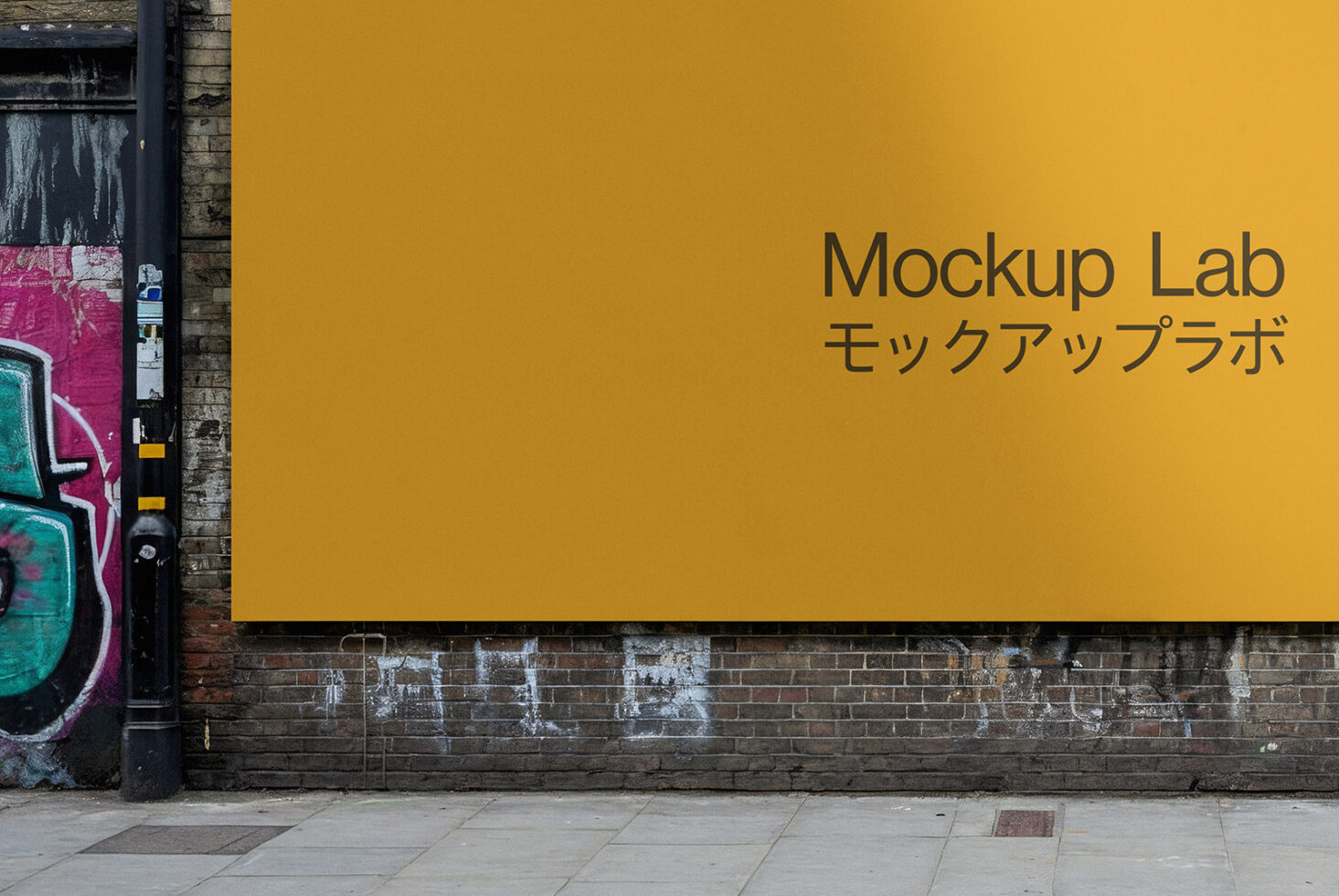 Mustard yellow billboard featuring Mockup Lab branding near colorful graffiti