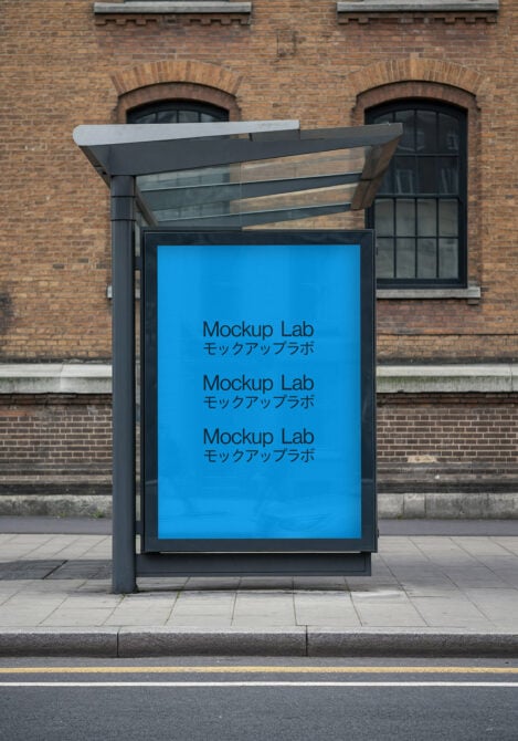 Bus shelter with bright blue poster showing repeated text on brick building backdrop