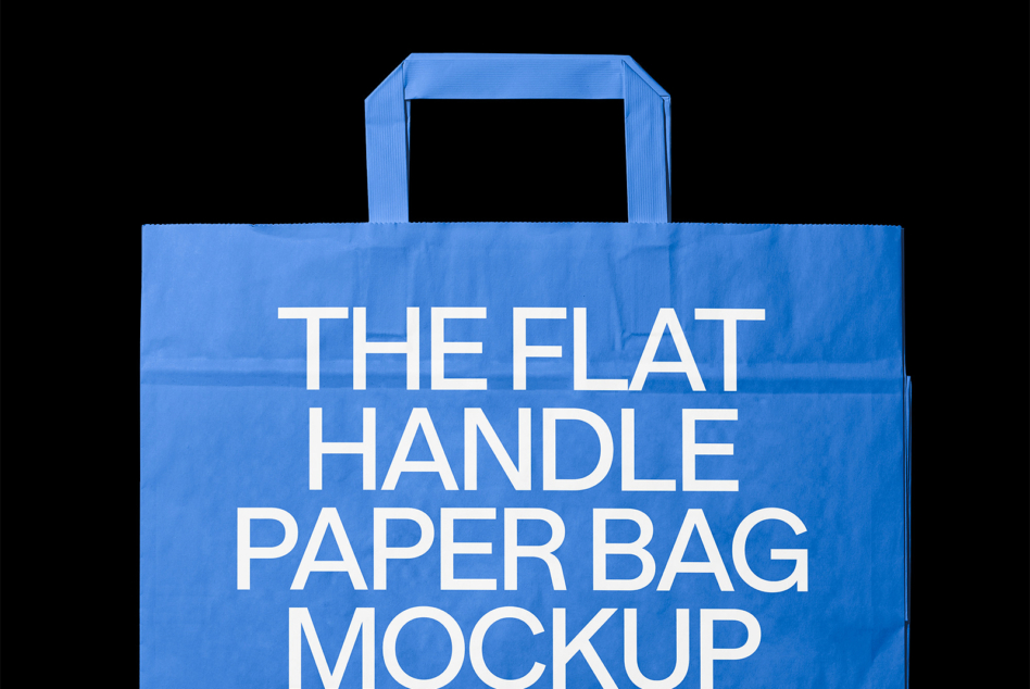 Bright blue paper bag with flat handles showing white text on black background
