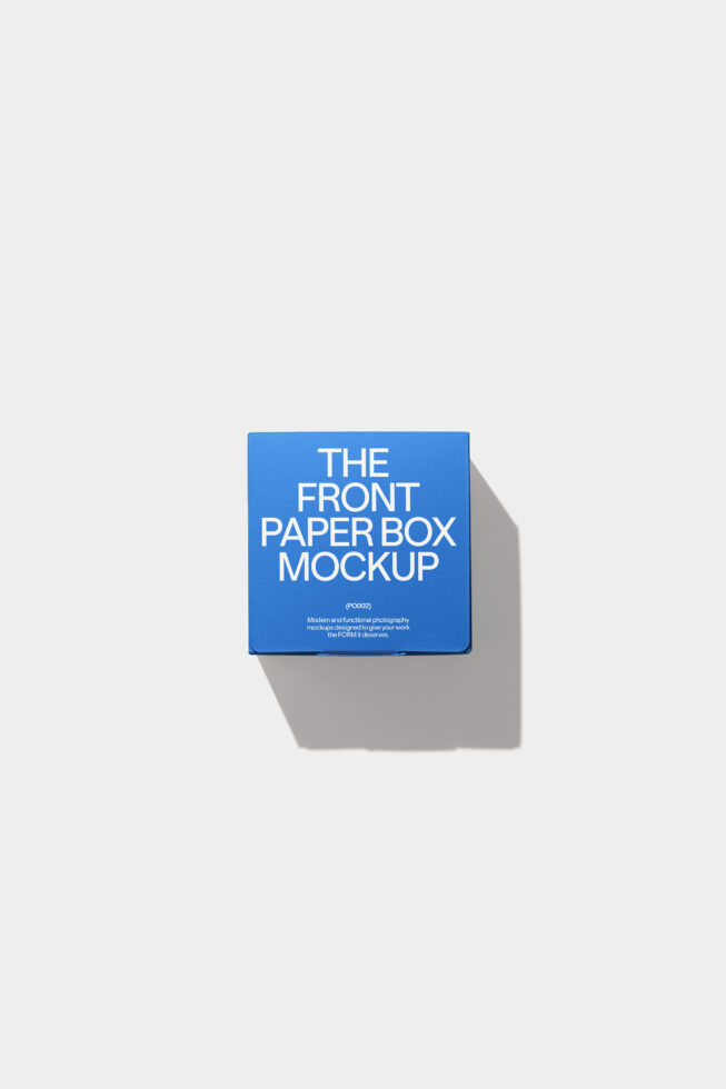 Small blue paper box mockup with white text casting sharp shadow