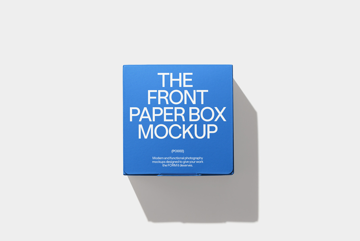 Blue paper box mockup on neutral background casting subtle gray shadow