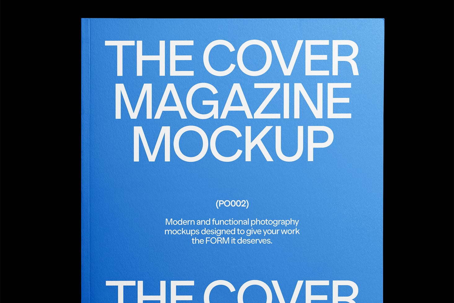 Overhead view of blue magazine cover mockup with white sans serif lettering