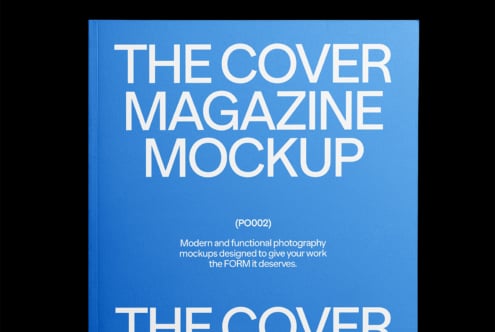 Overhead view of blue magazine cover mockup with white sans serif lettering