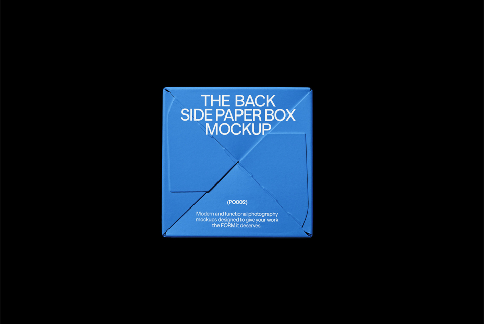 Blue cardboard box mockup on black background with diagonal creases