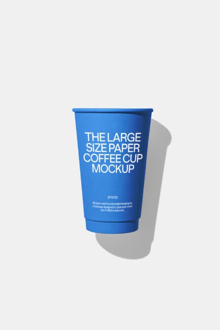 Blue paper coffee cup mockup with white text on light background casting shadow