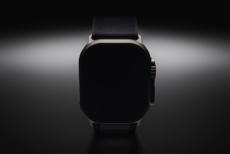 Smartwatch with black strap, blank screen, front view on gray background