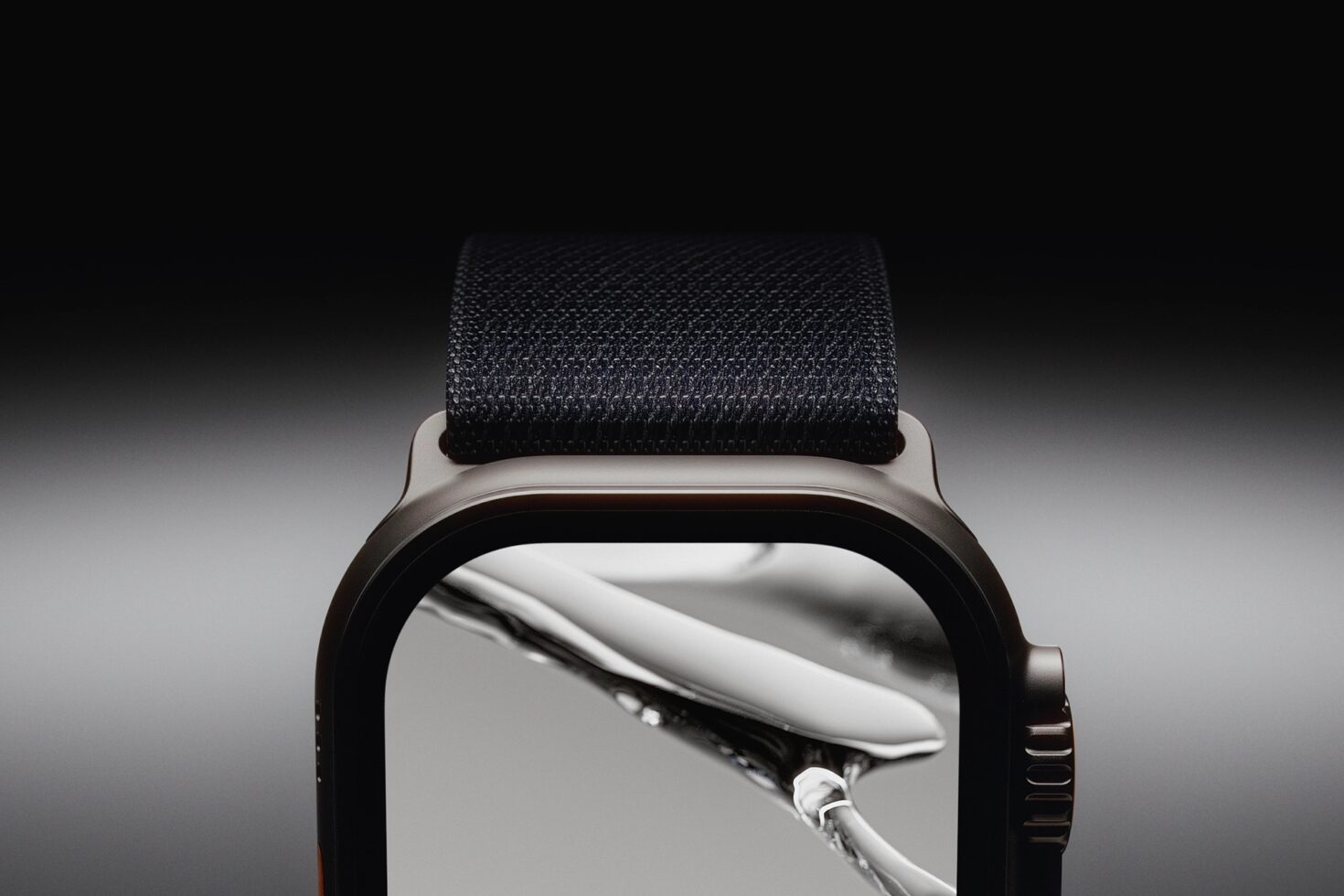 Smartwatch with black fabric band showing nature photo on curved display