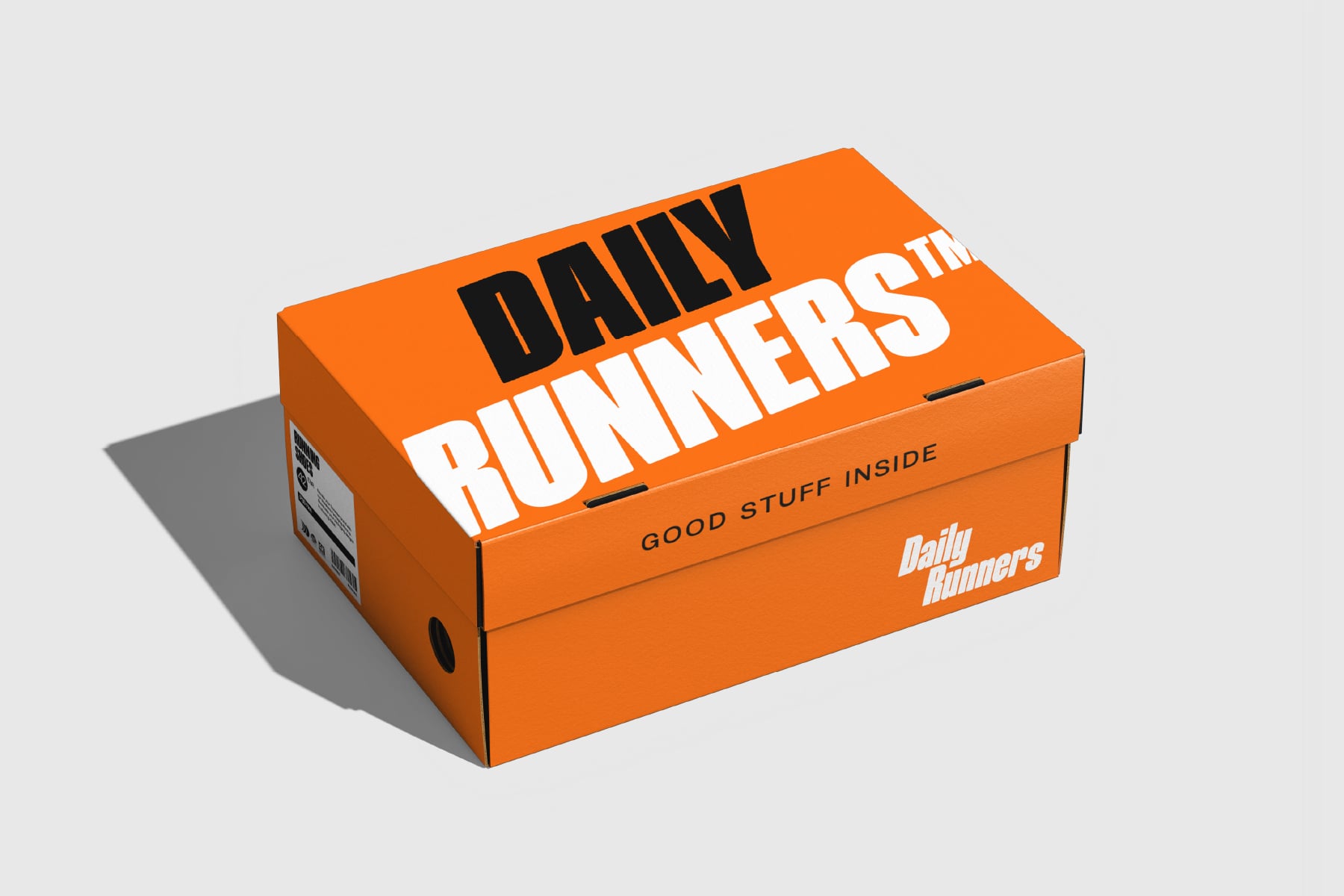 Bright orange shipping box for Daily Runners with bold white lettering