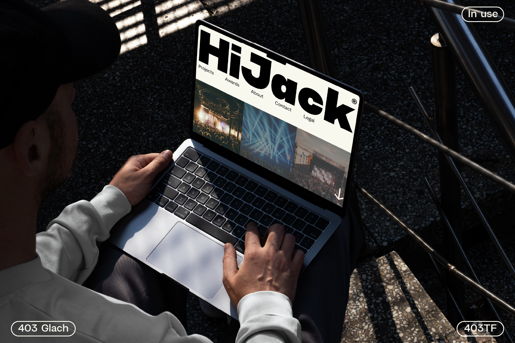 Laptop displaying HJSqck website with navigation menu in natural daylight