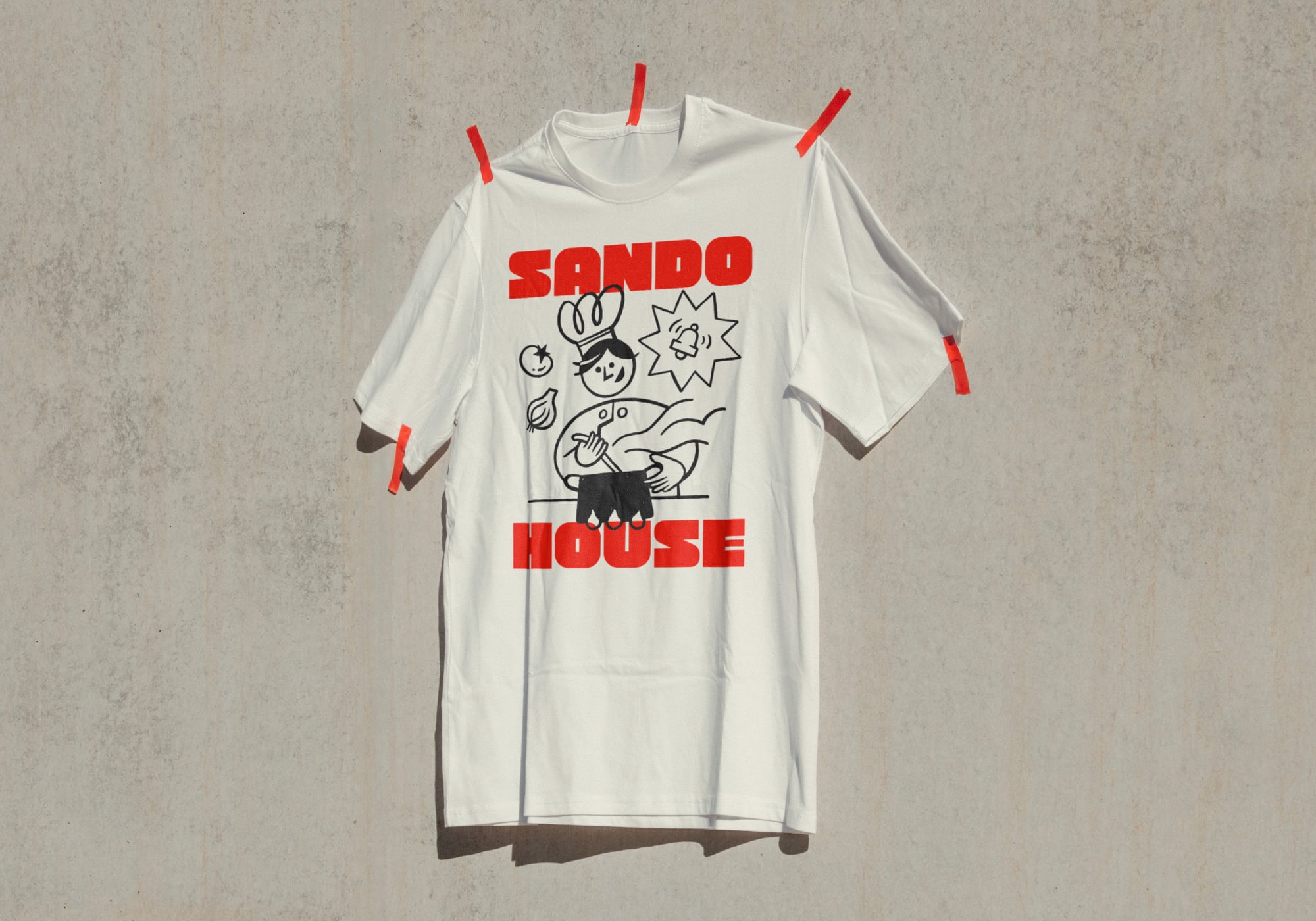 White tee with Sando House graphic print on clothesline with red clips