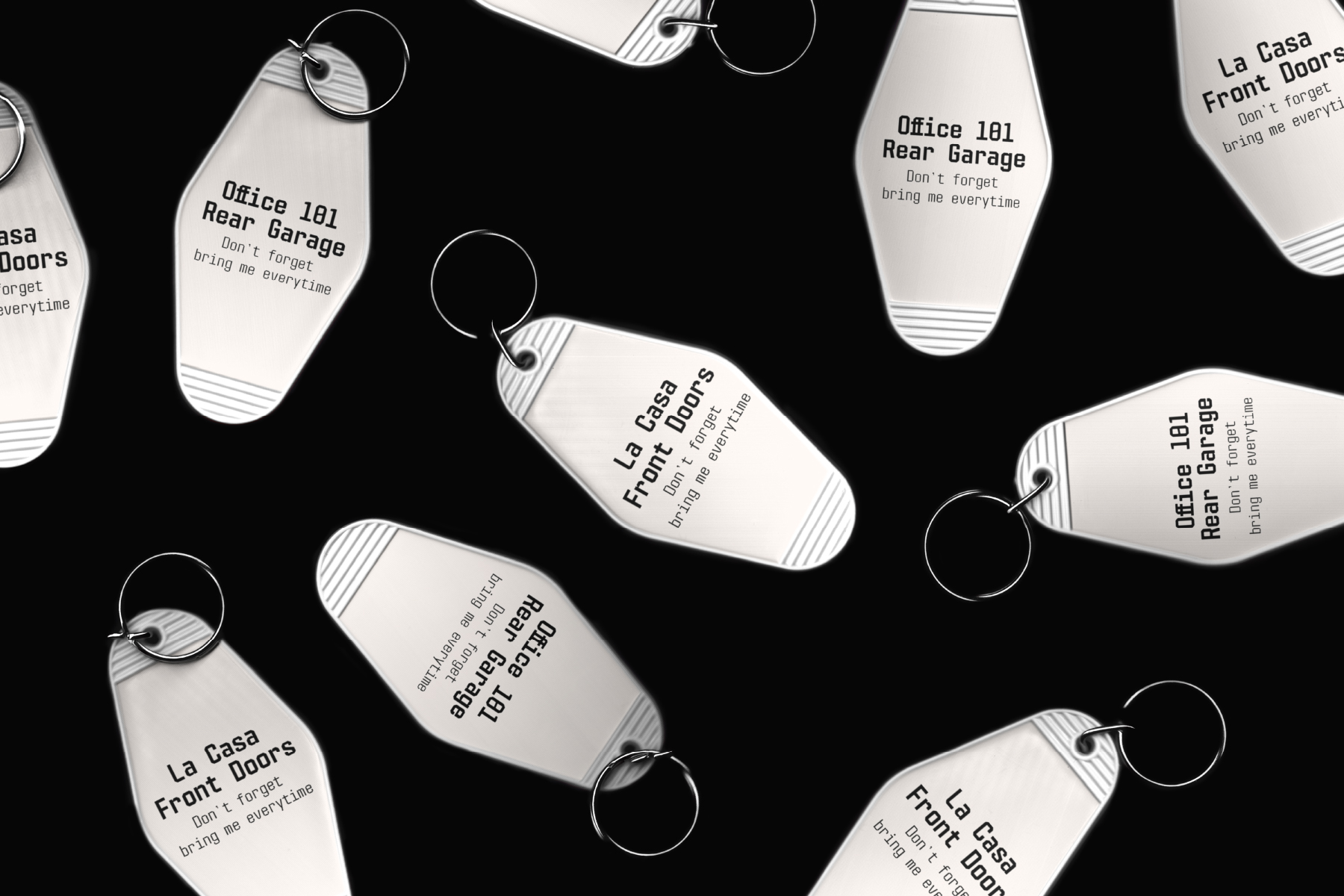 Vintage motel key tags with printed addresses scattered on black