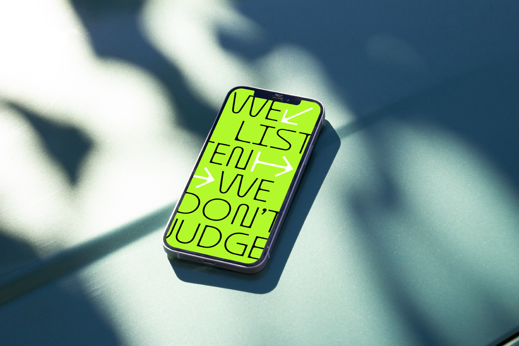Smartphone screen displaying neon yellow text that reads We list everything we dont judge