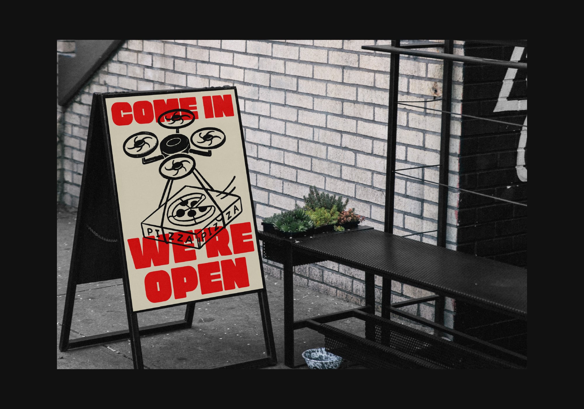 Street sandwich board sign with red come in we're open text over pizza icon