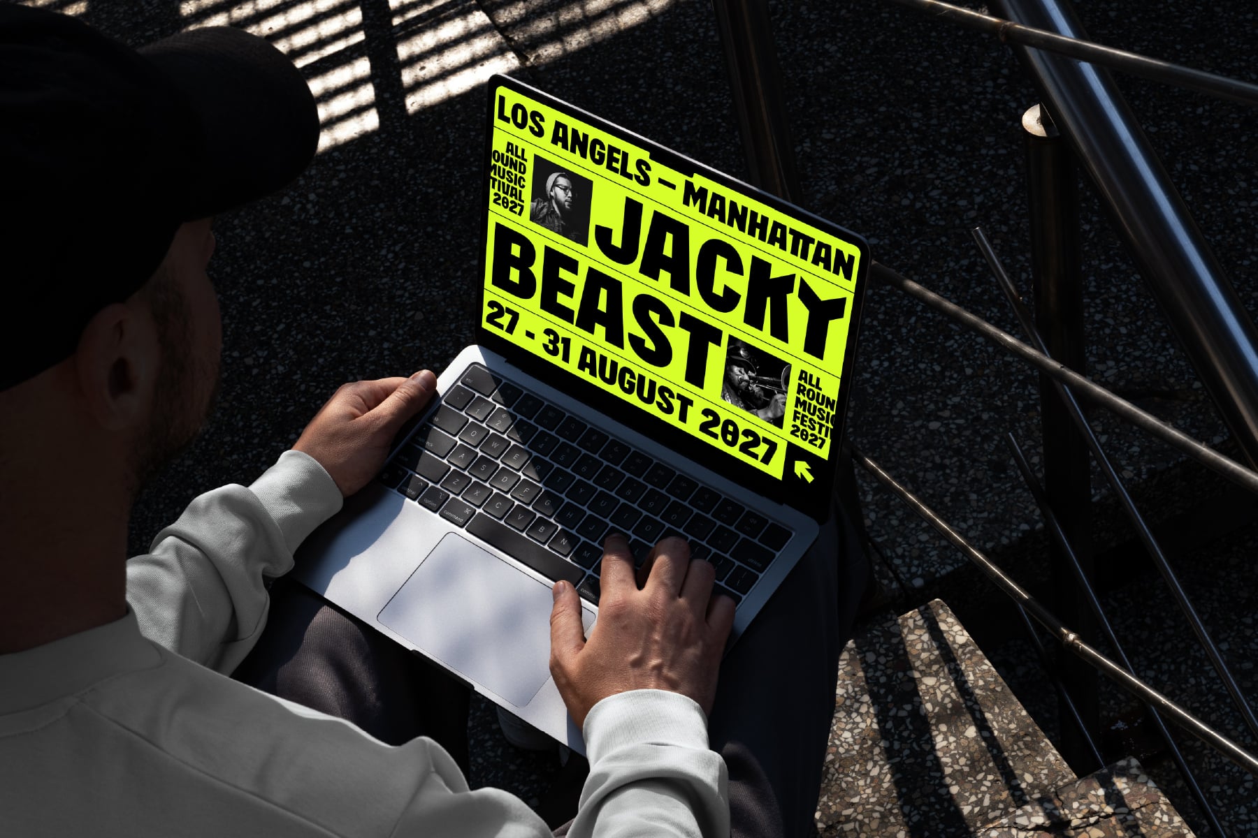 Laptop screen displaying neon yellow event poster on red car with shadow reflections