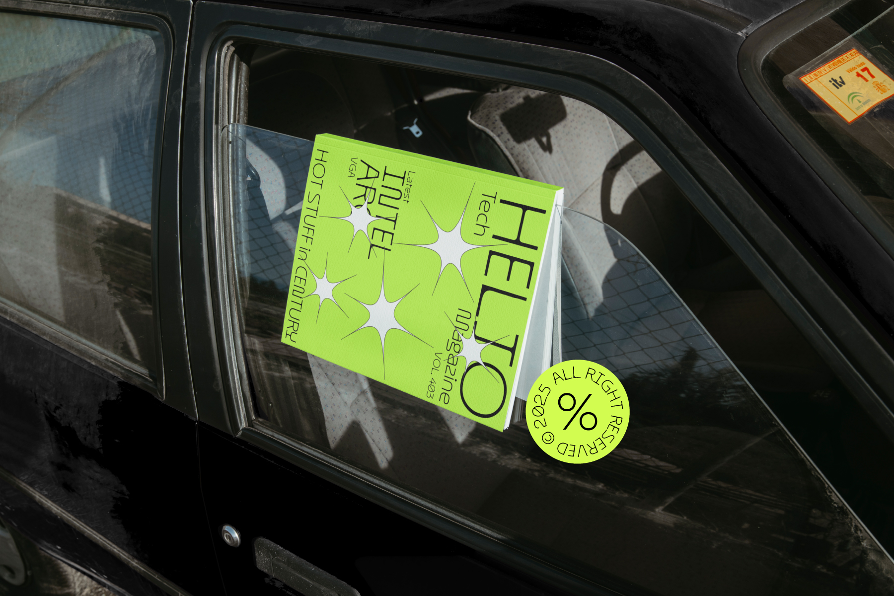 Bright green booklet on car window showing HELLO Tech typography mockup
