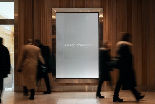 Large illuminated display frame mounted on wood wall with blurred people walking past