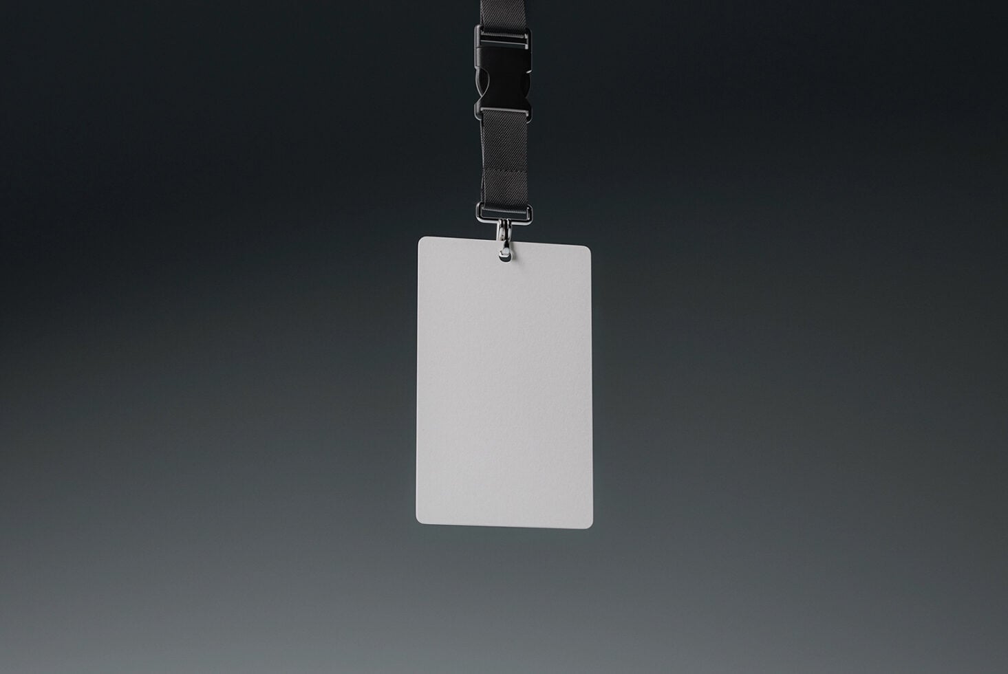 Blank white vertical badge mockup attached to dark fabric lanyard