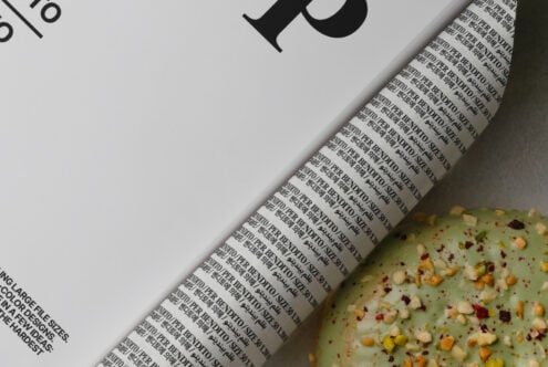 Light book cover detail with repeated text pattern near seeded crackers