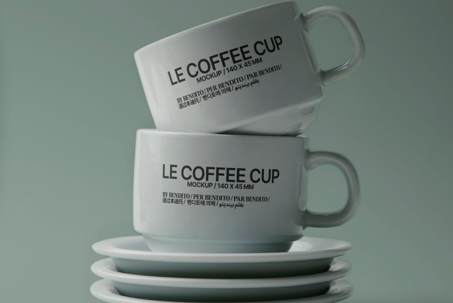 Stacked ceramic mugs with Le Coffee Cup branding on sage green background