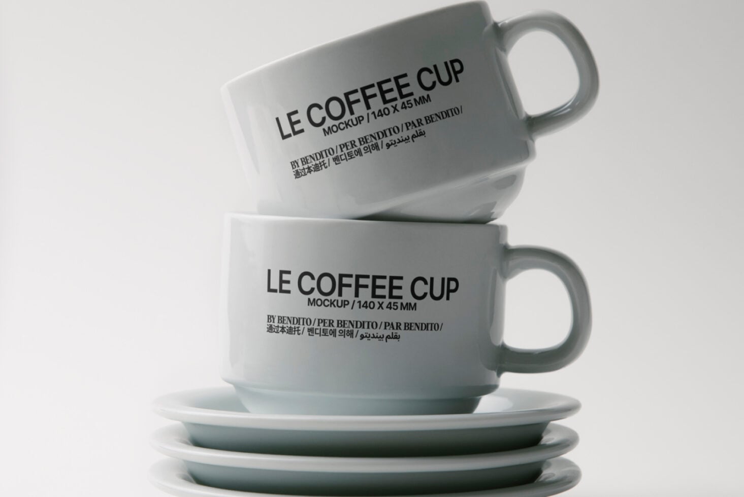 Two ceramic mugs with Le Coffee Cup text stacked on matching saucers