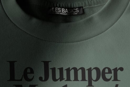 Sage green sweatshirt with Les Basics woven neck label showing Le Jumper text