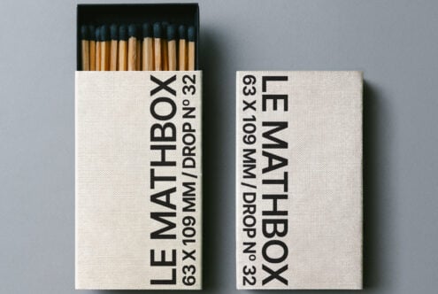 Off white matchbox with black text showing specs, dark blue match tips inside