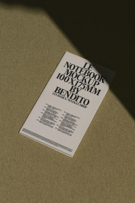 White notebook mockup on linen fabric with overhead sunlight