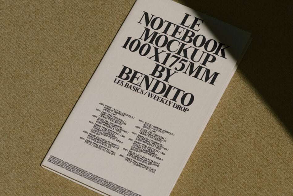 Cream notebook cover with black serif typography, angled on textured background