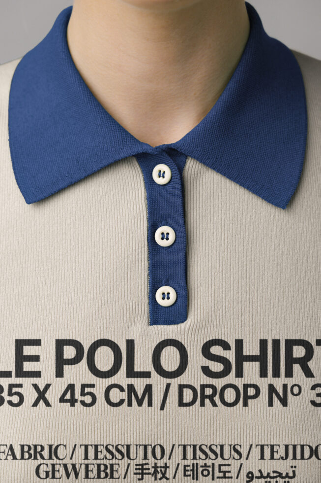 Close-up of cream polo shirt with navy blue collar, product specs text visible