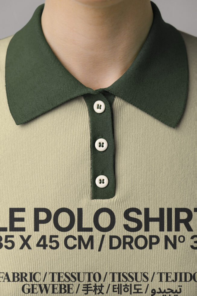 Close-up of cream polo shirt with forest green collar, product specs text visible